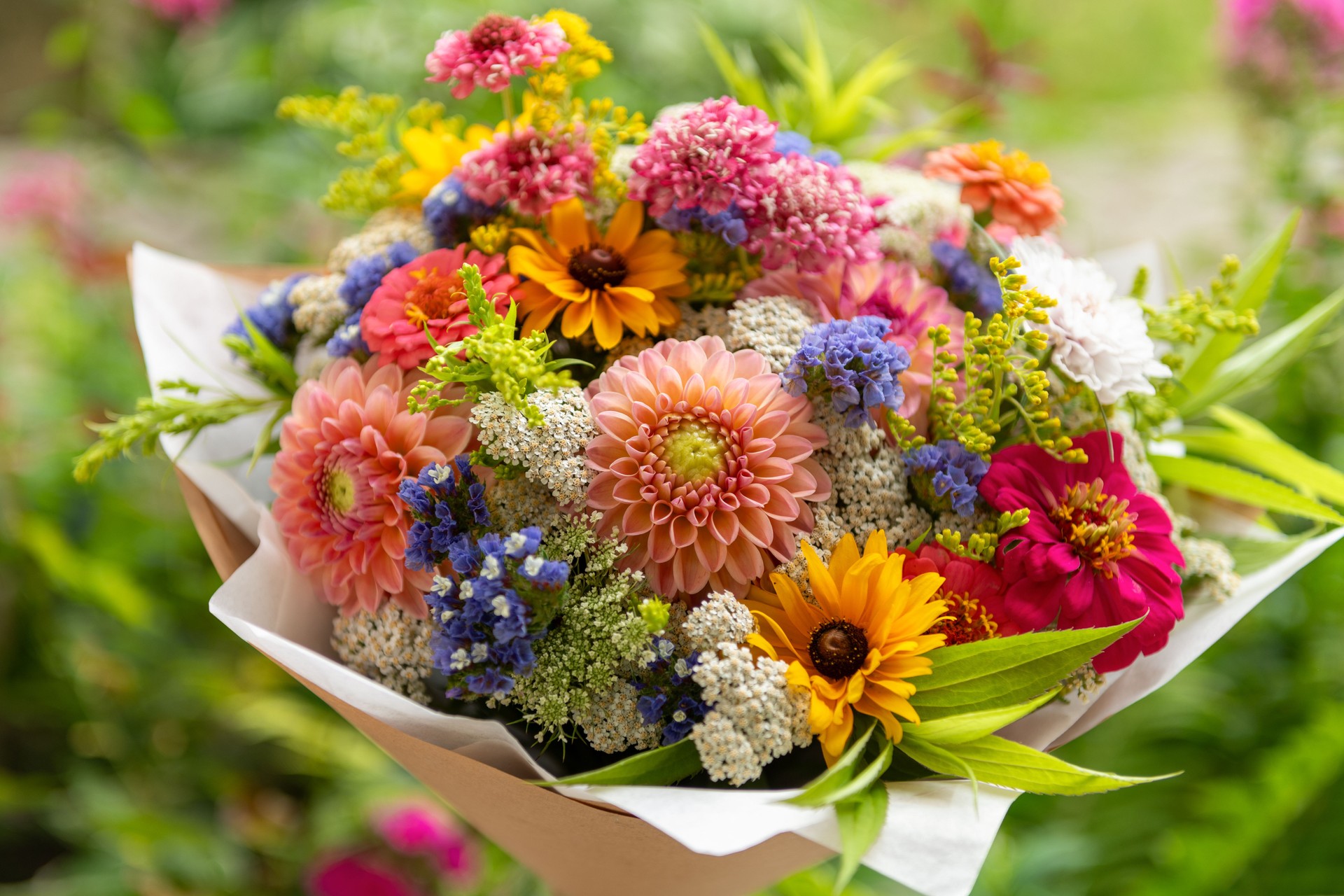 Summer bouquet. Beautiful multi colored fresh flower arrangement. Birthday bouquet made of summer flowers photographed outdoors.